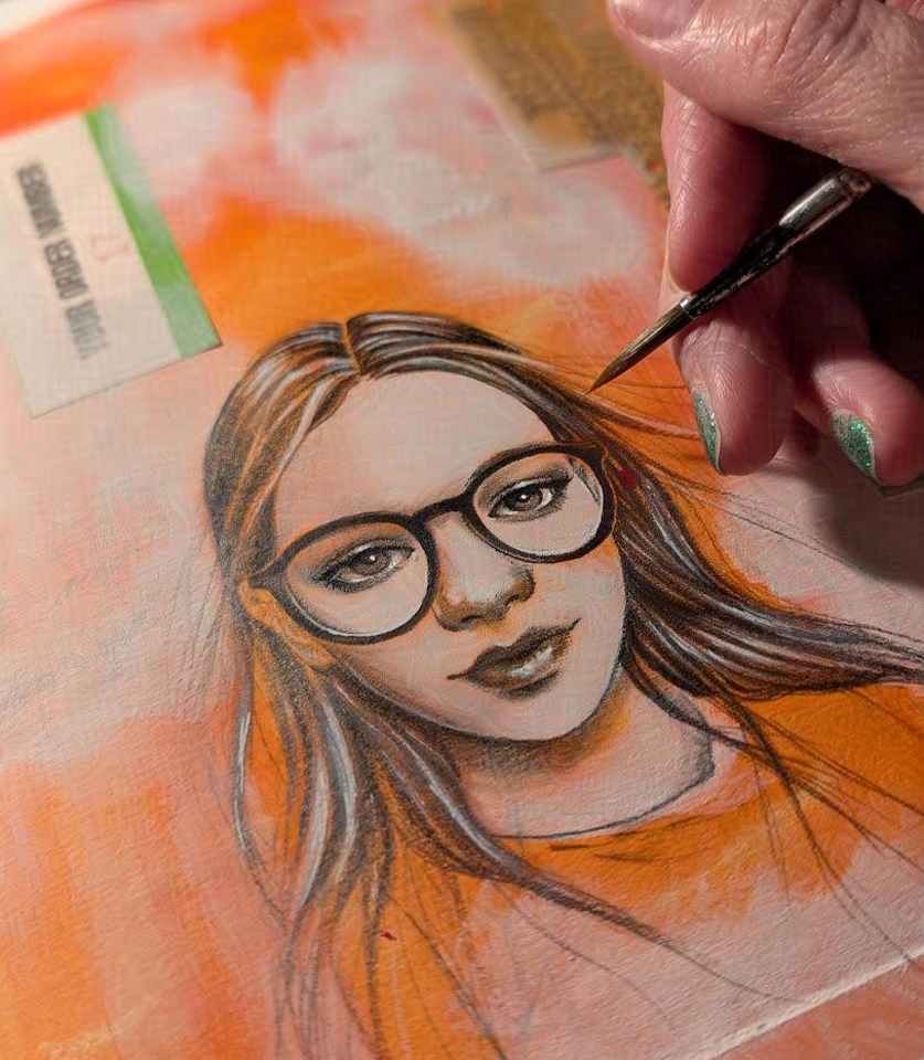 A page from my sketchbook. the background is orange with bits of paper collaged onto it, then drybrushed over with white medium. The drawing is a graphite drawing of a girl's face. She had black glasses and long, straight hair. My hand is just looming into the edge of the photo, holding a paintbrush. 